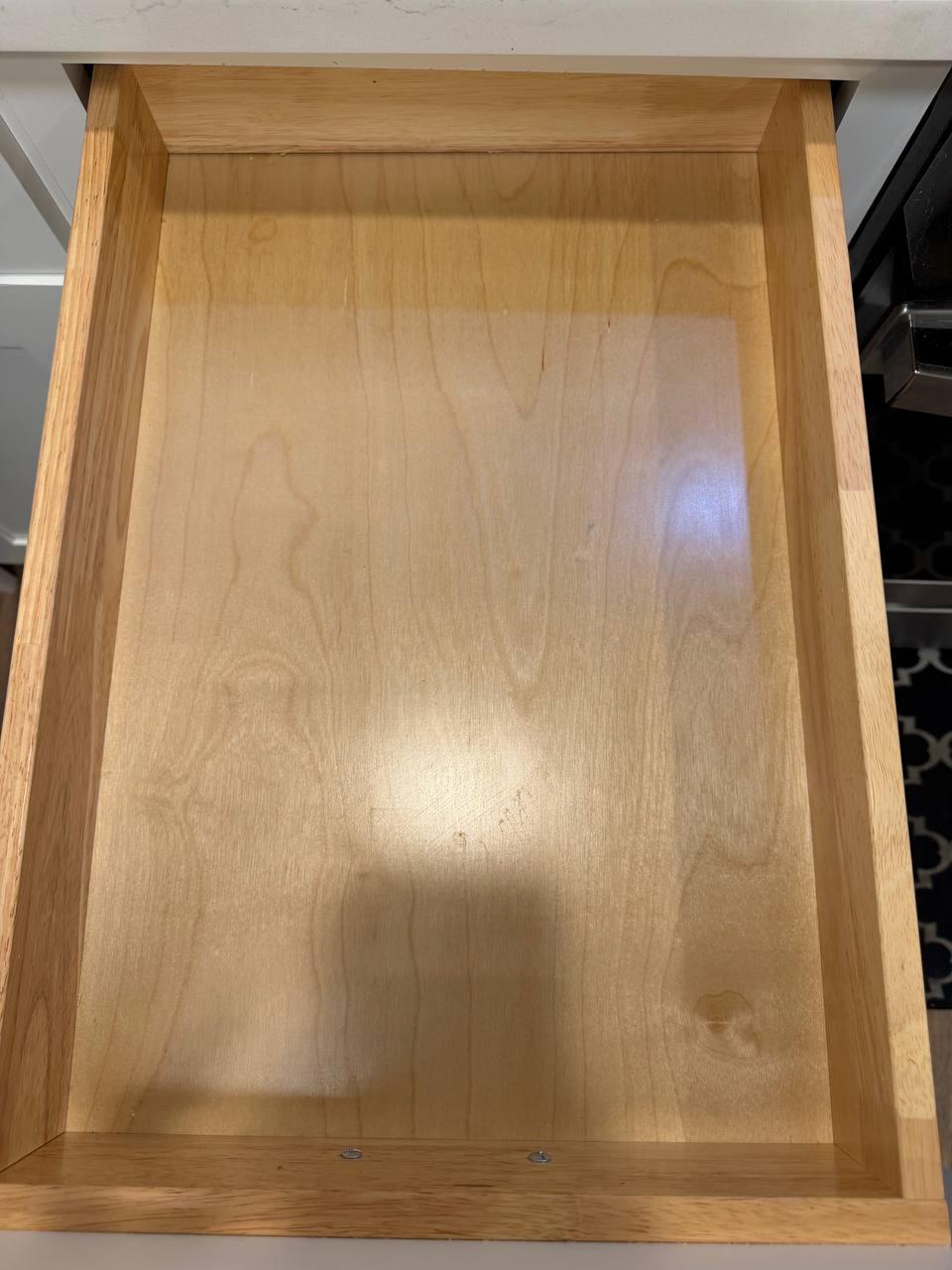 Empty wooden kitchen drawer pulled open