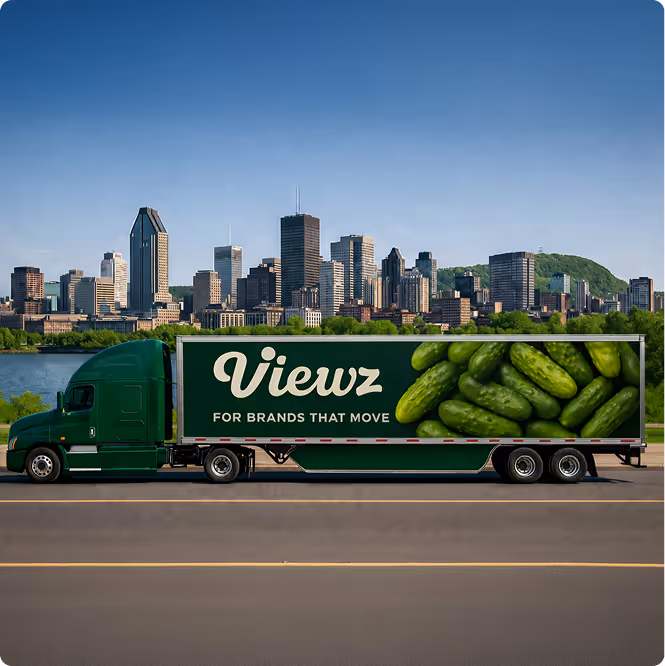 Green truck with 'Viewz for brands that move' and large cucumbers image on trailer, city skyline background.