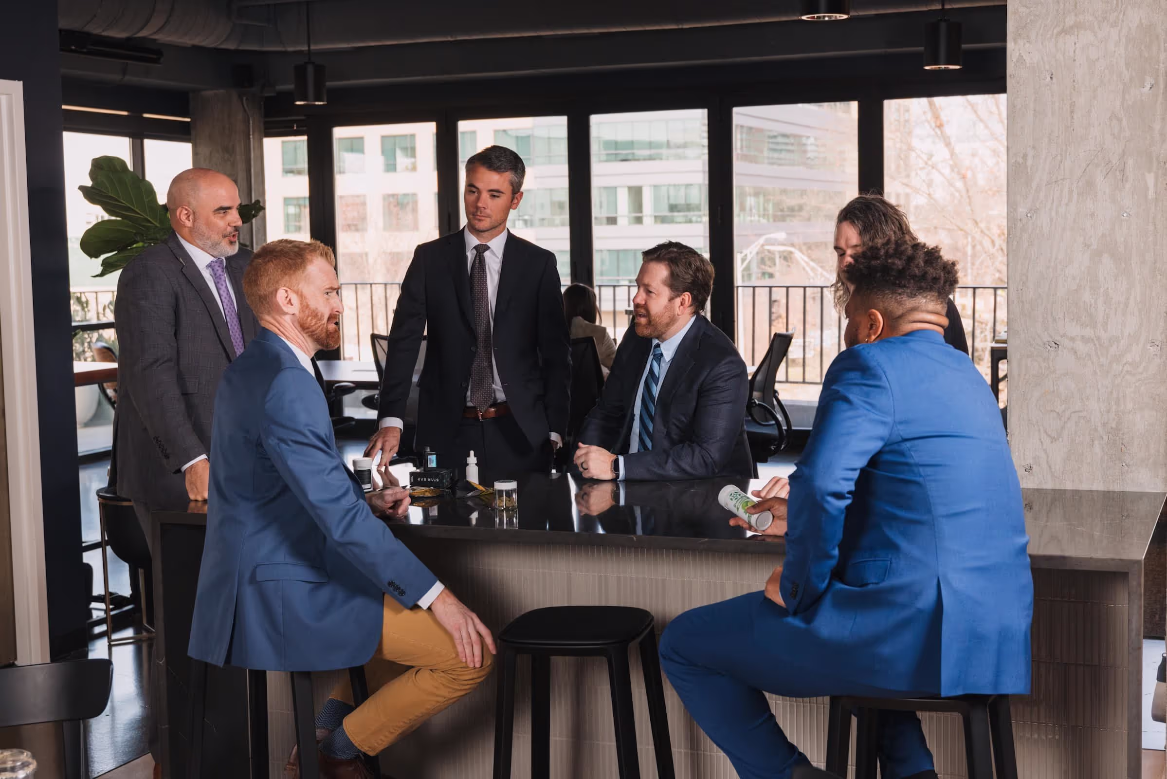 Business people gathered at a bar