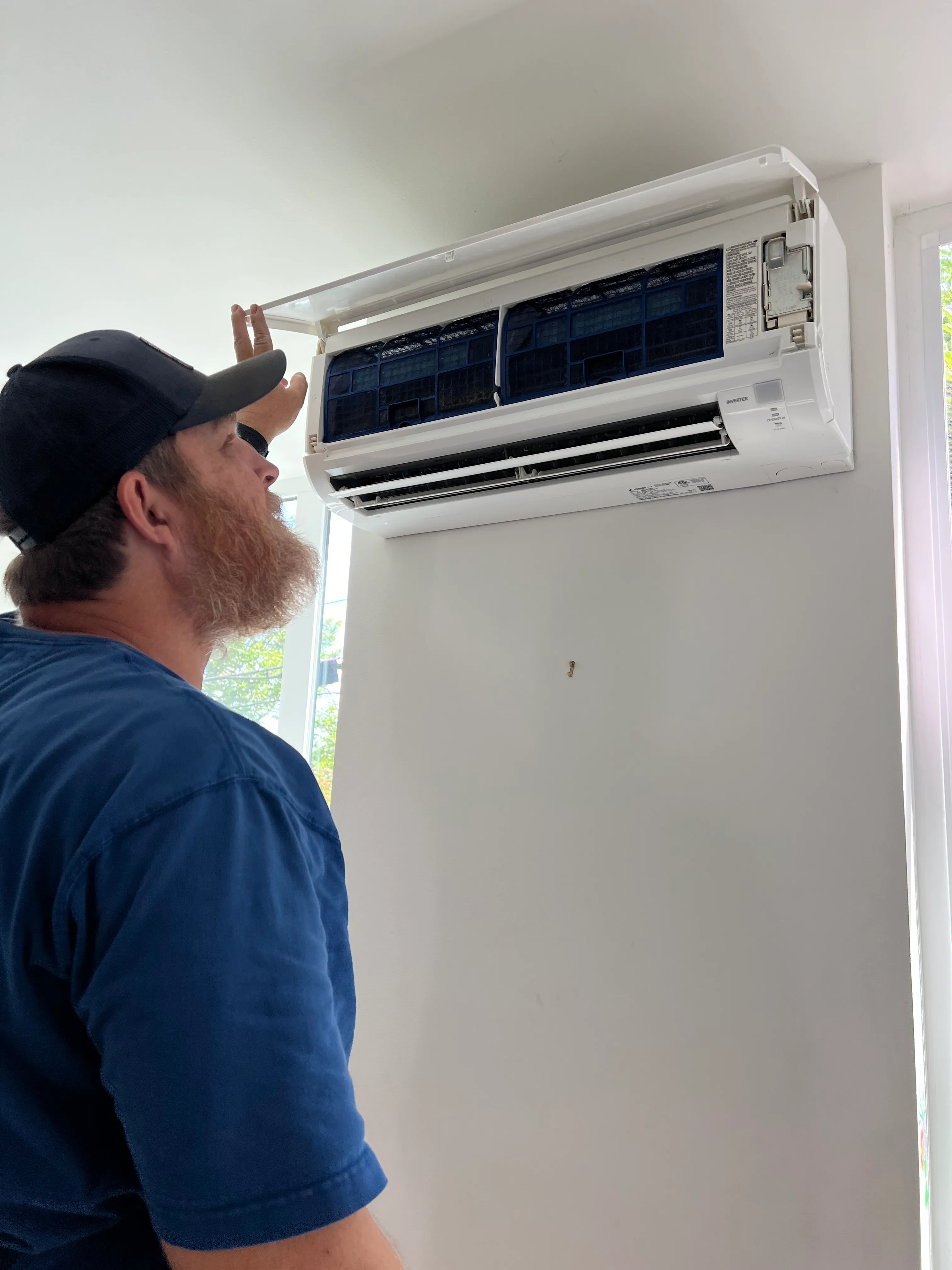 hvac repairman working on a ductless unit