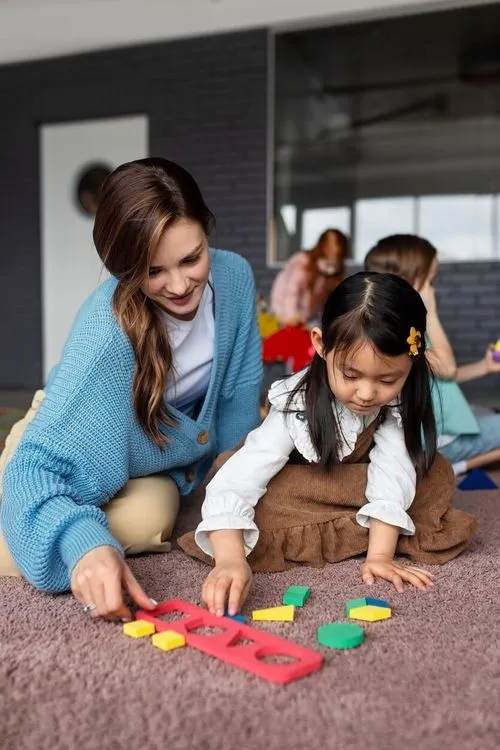 Montessori preschool teacher helping child with learning shapes at OC Toddler School in Irvine CA