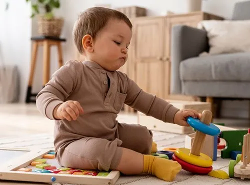Infant playing with Montessori sensory toys during Infant and Toddler program at OC Toddler School in Irvine CA