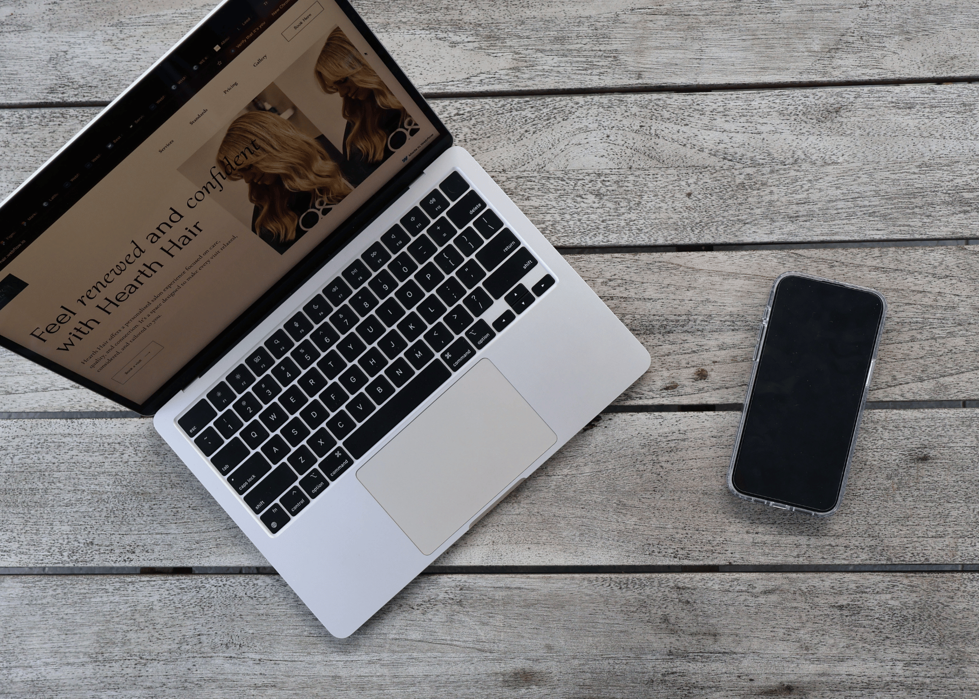 Flat lay of a DSLR camera and MacBook on a wooden desk — representing creative branding and digital content creation at In Sync Creative.