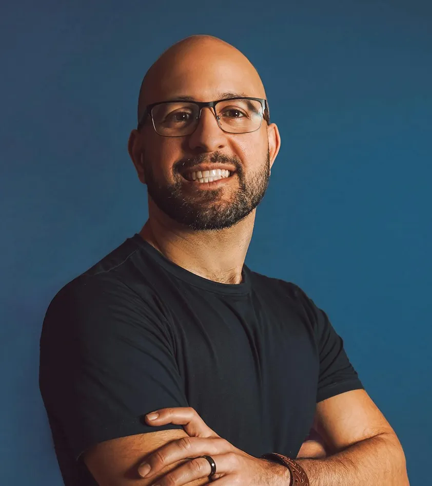 A man wearing glasses and a black shirt.