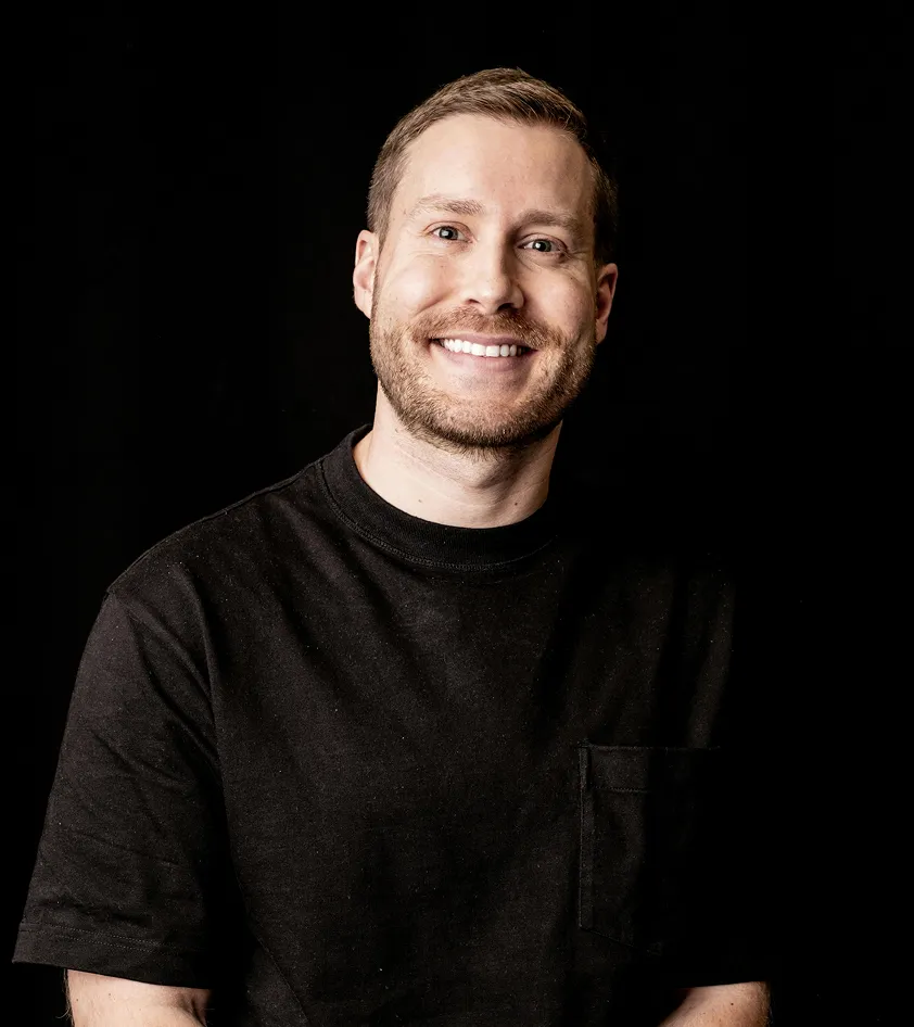 A man with a beard and a black shirt.
