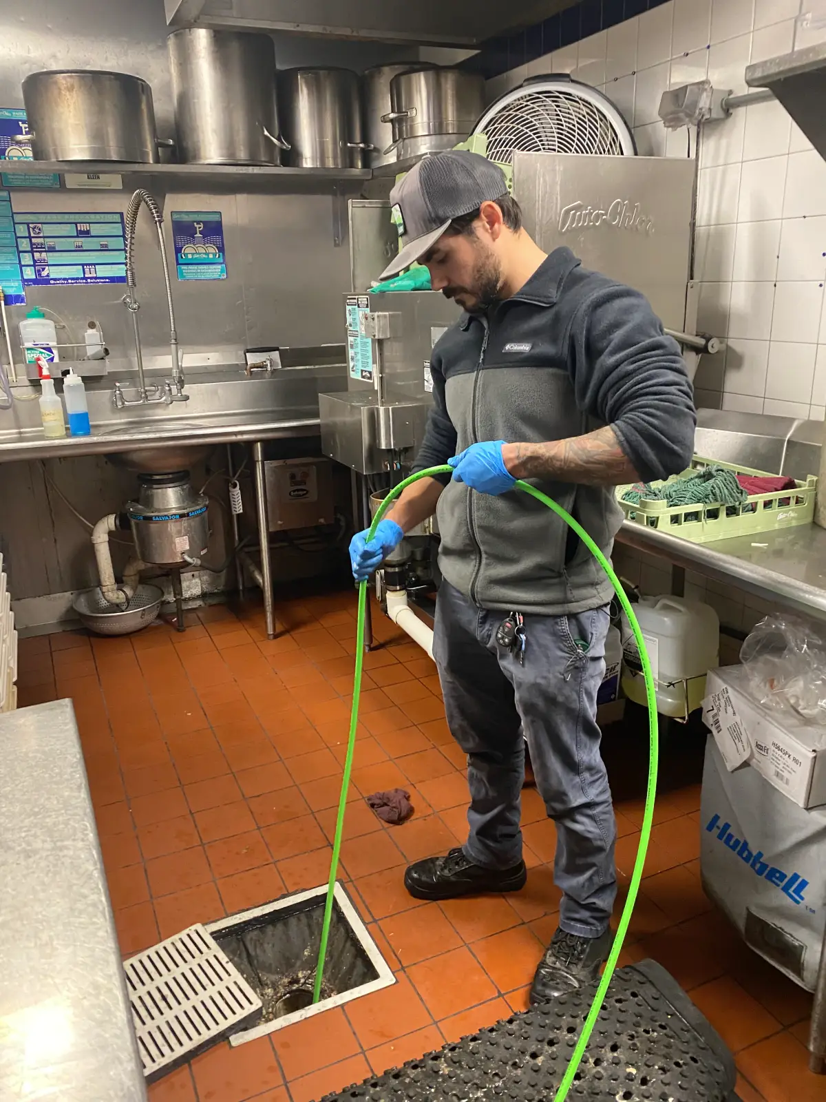 man jetting floor drain