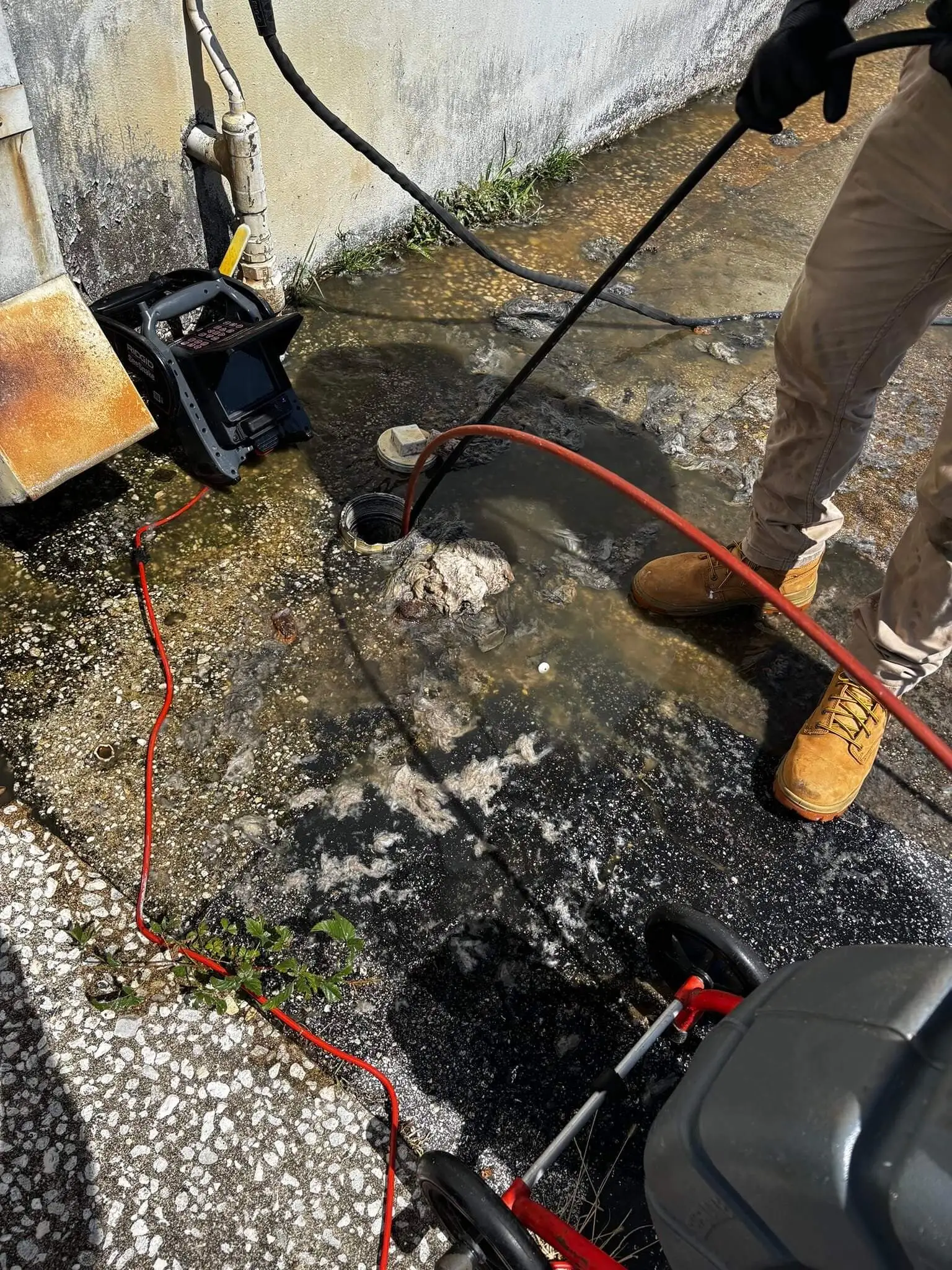 plumbing cleaning out a drain