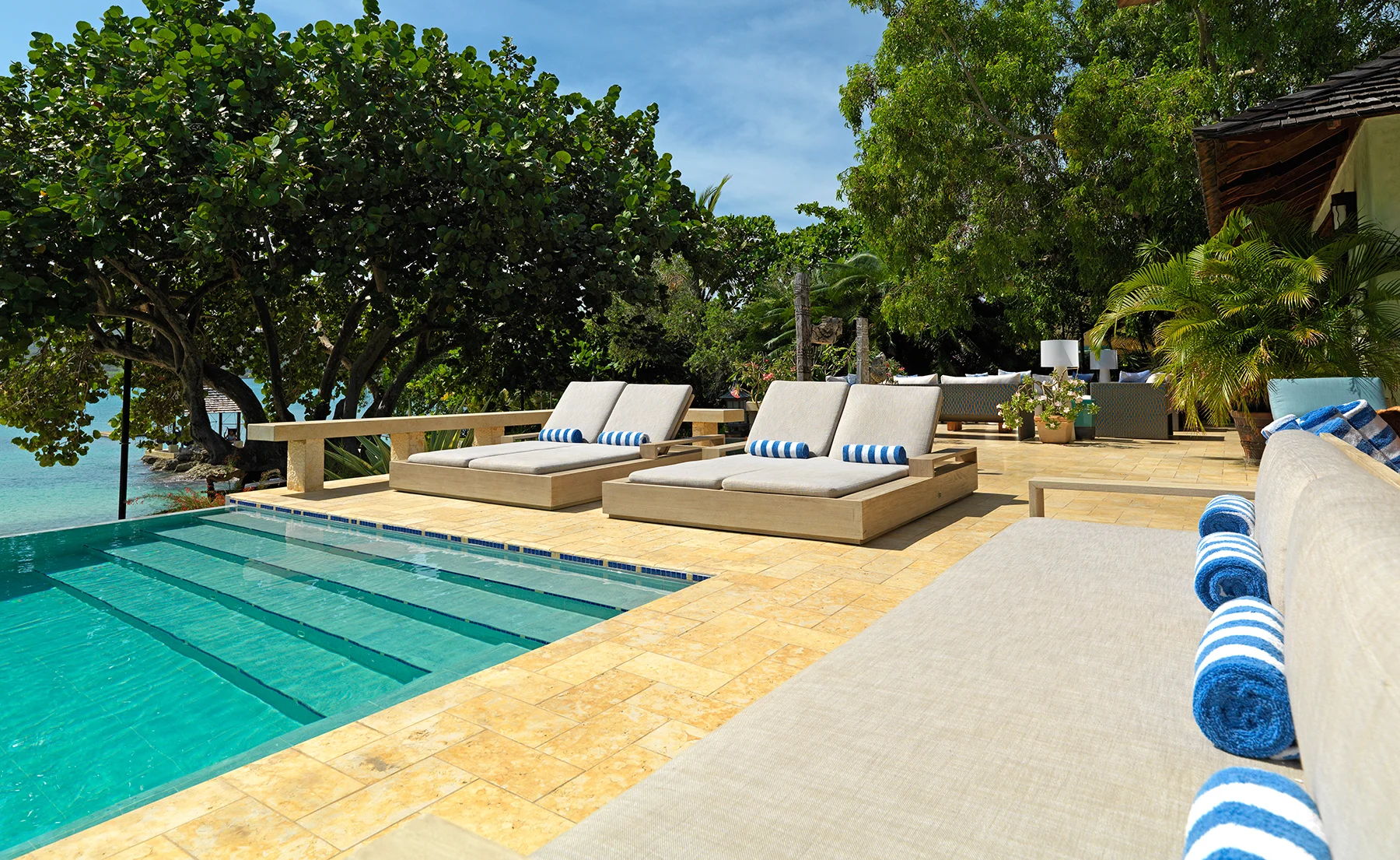 Poolside scene with sun-loungers and towels