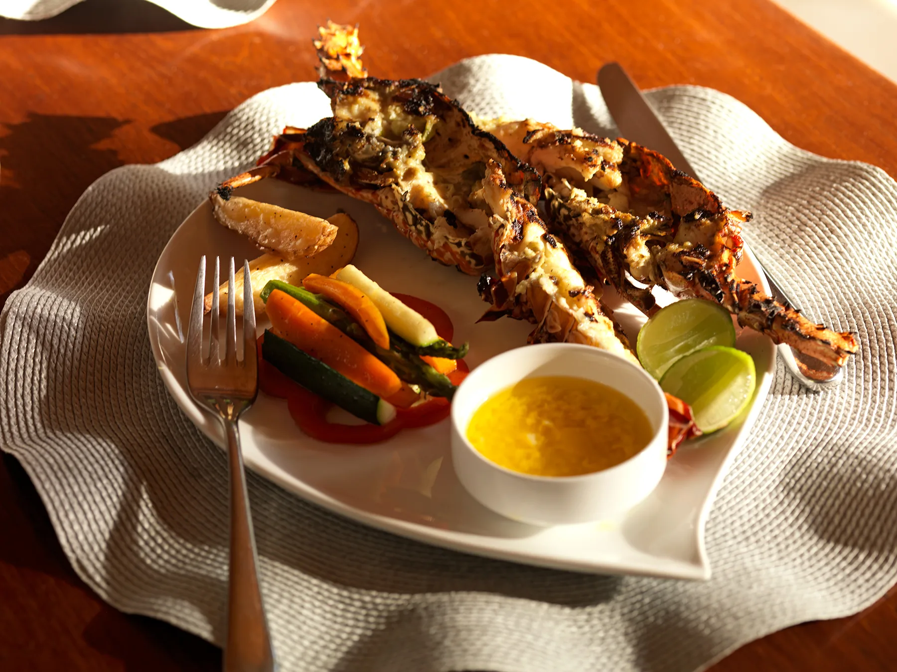 Plate of grilled fresh lobster with vegetables