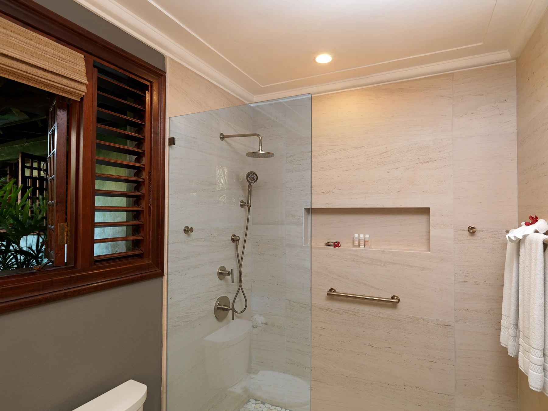 Modern en-suite bathroom with a glass enclosed shower