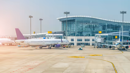 A couple of airplanes parked at an airport.