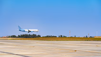 An airplane taking off from an airport runway.