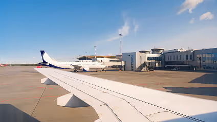 The wing of an airplane as it sits on the tarmac.