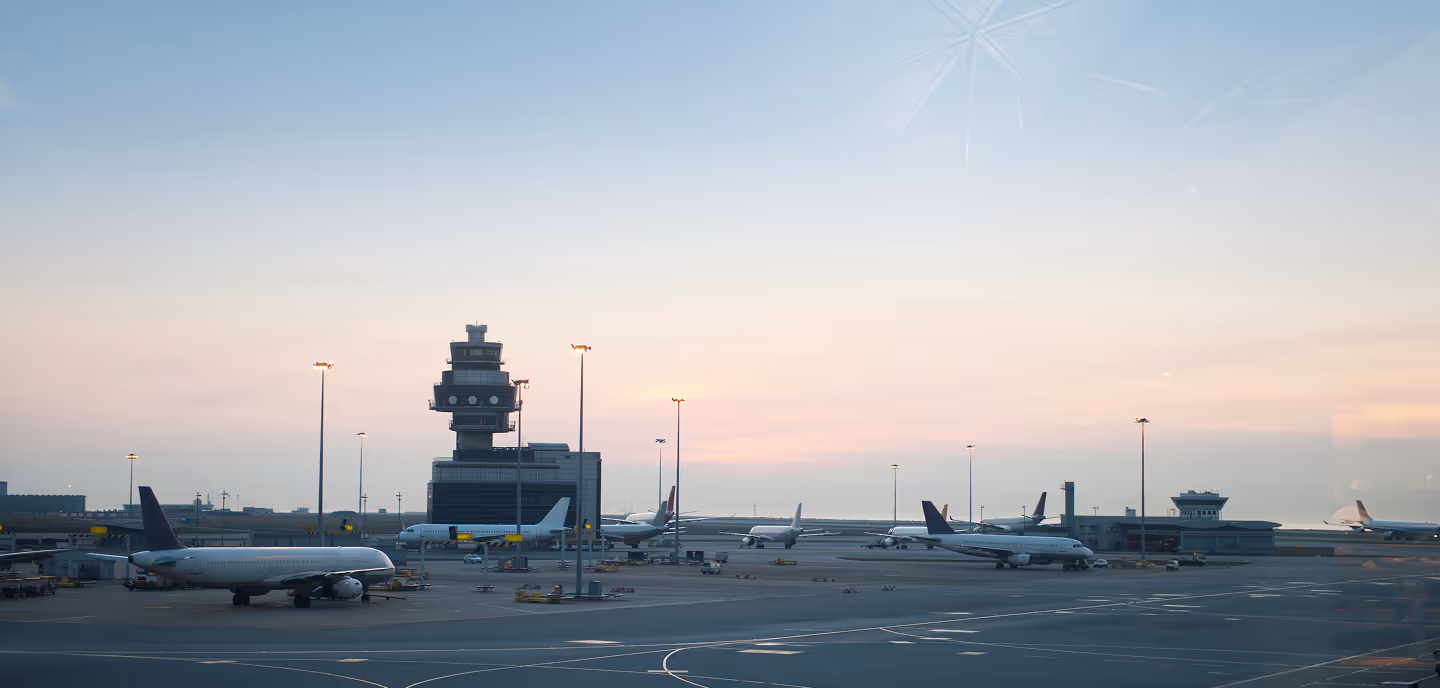 An airport with several planes parked on the tarmac.