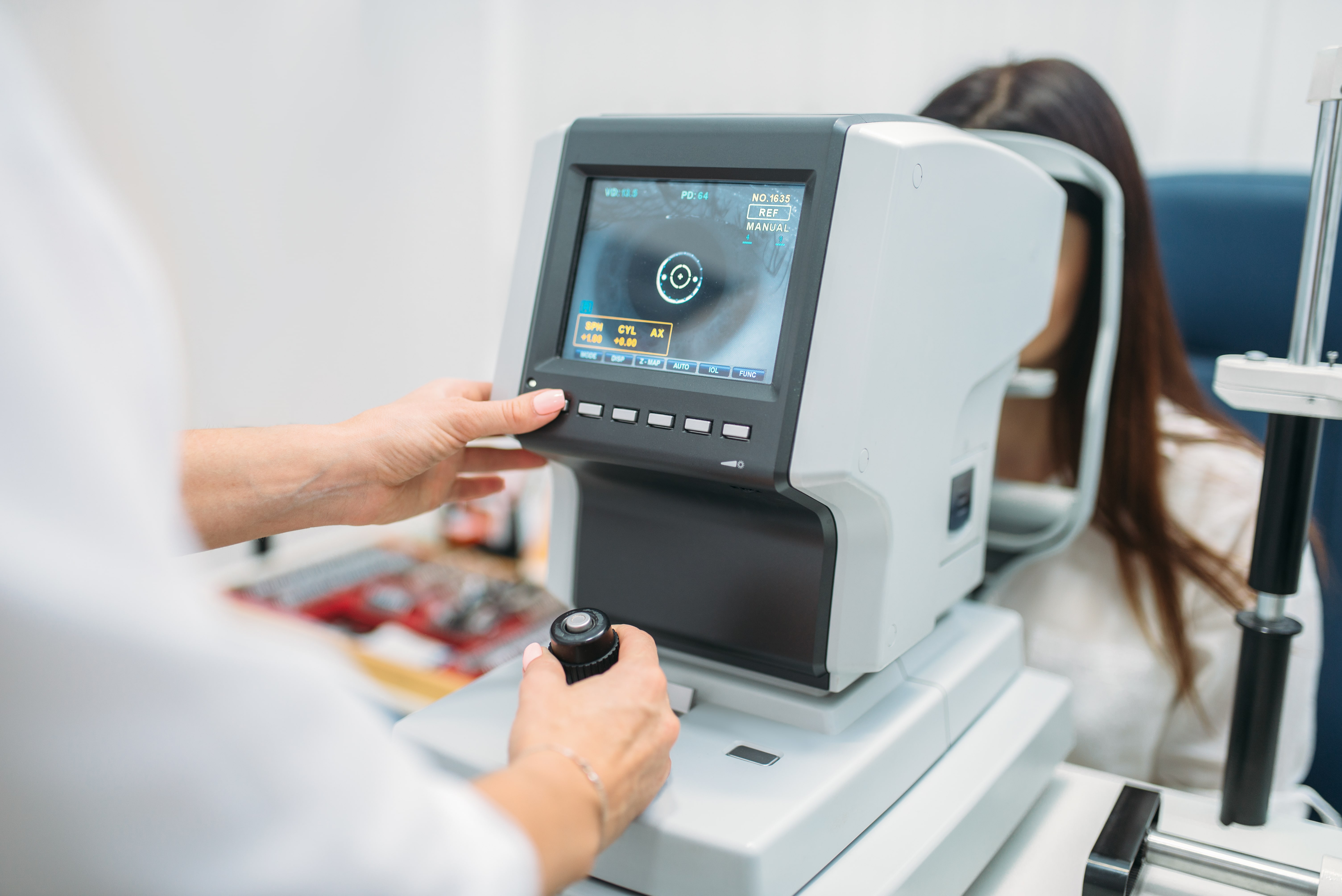 Eye examination machine displays detailed eye scan with patient