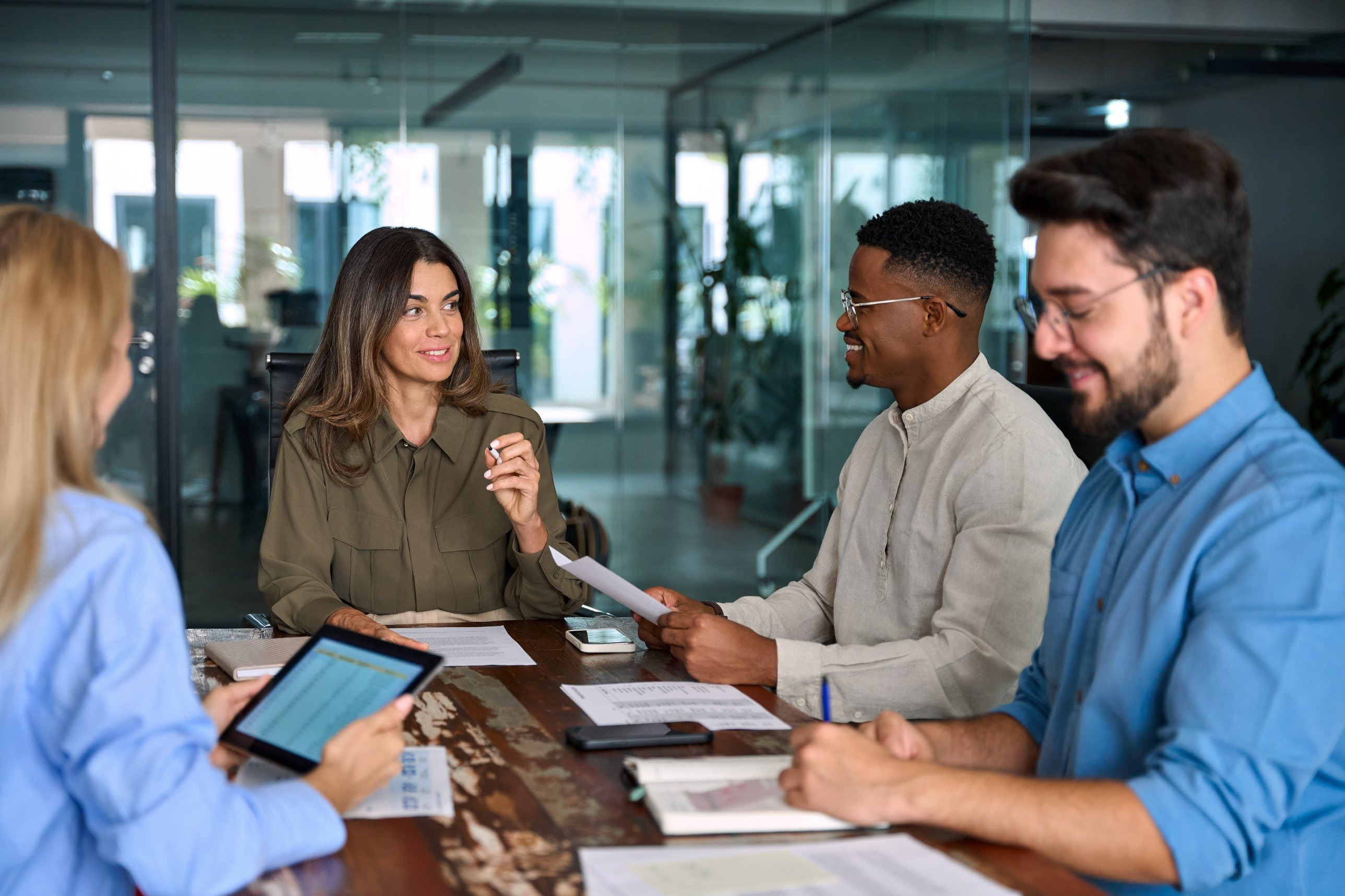 A carrier sales team reviewing a submission together around a table