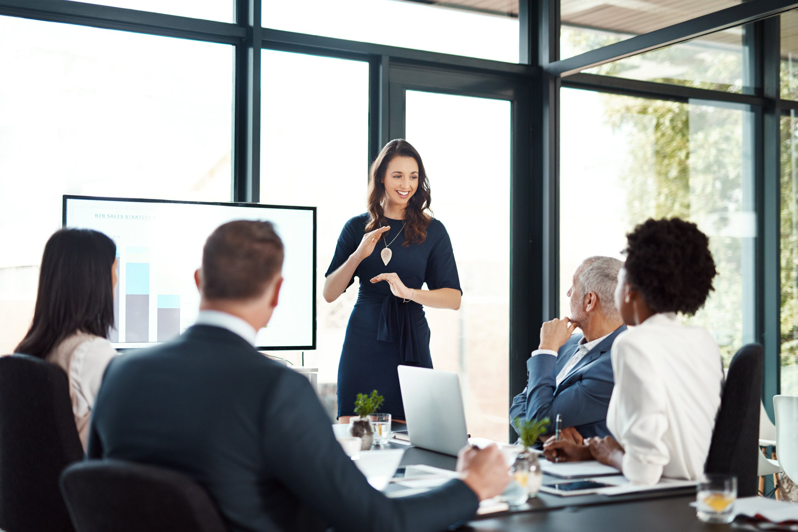 A sales leader presenting results to her team