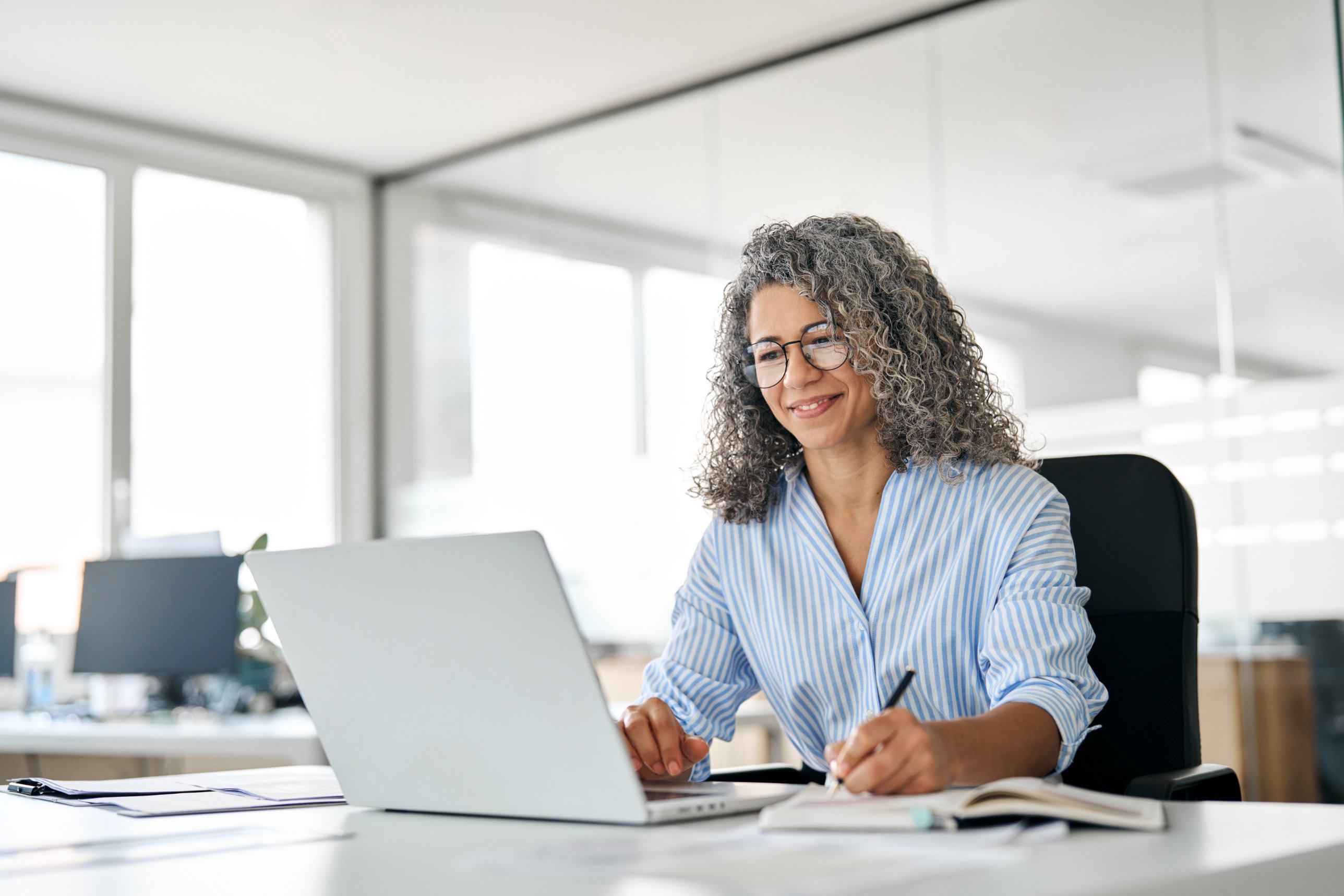 A benefits consultant working at her laptop