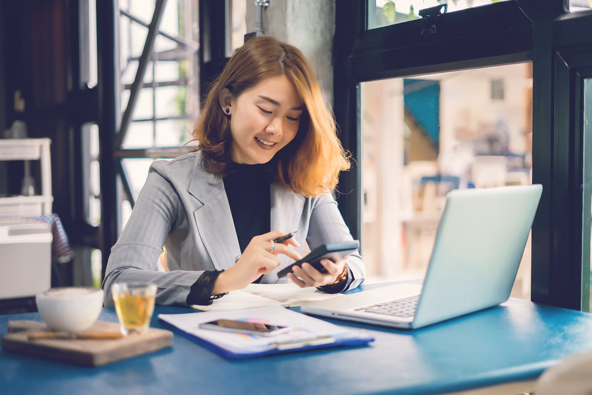 Woman calculating costs at a desk — representing cost optimization