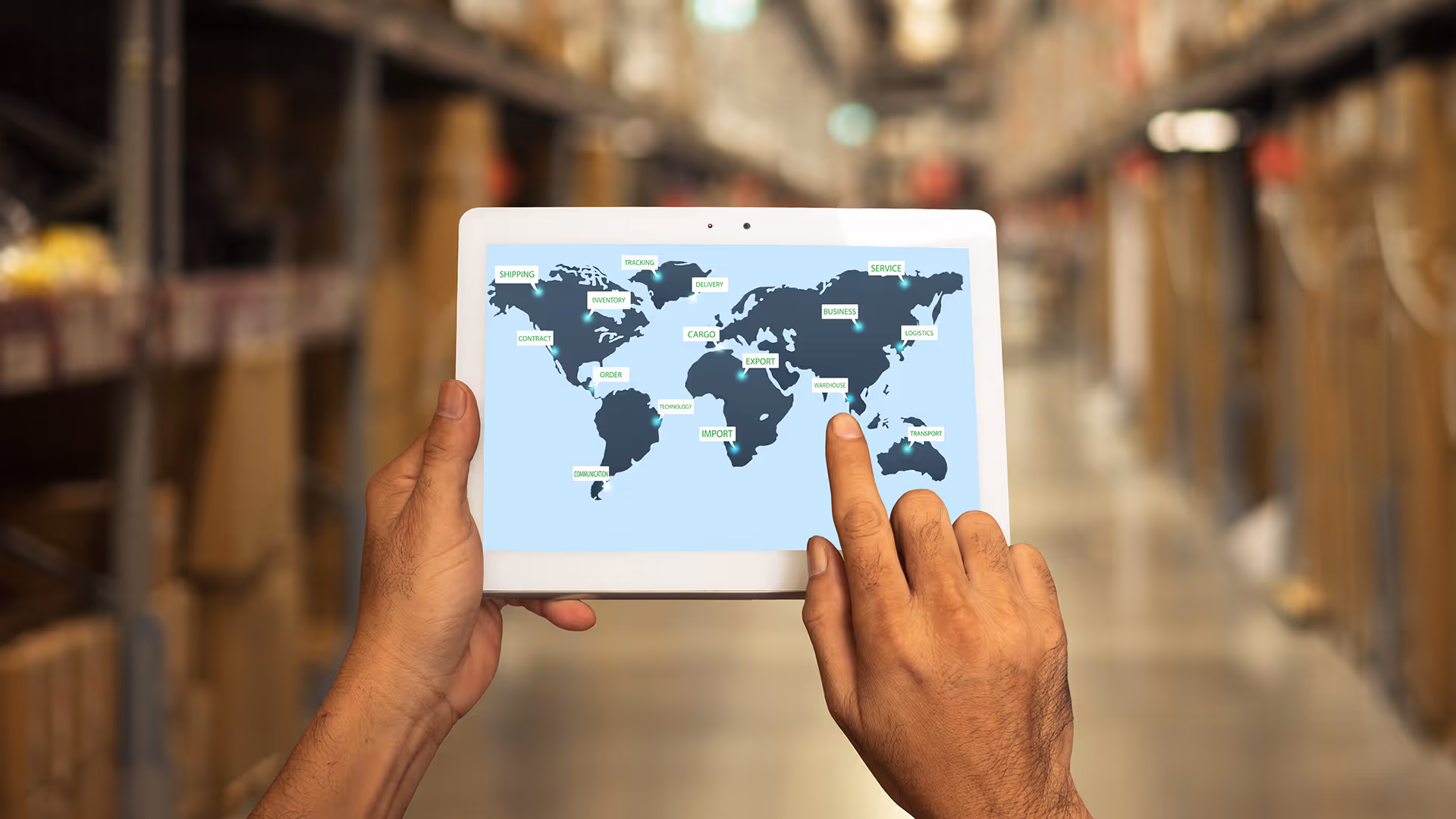 A person managing global logistics via a map overlay on a tablet device