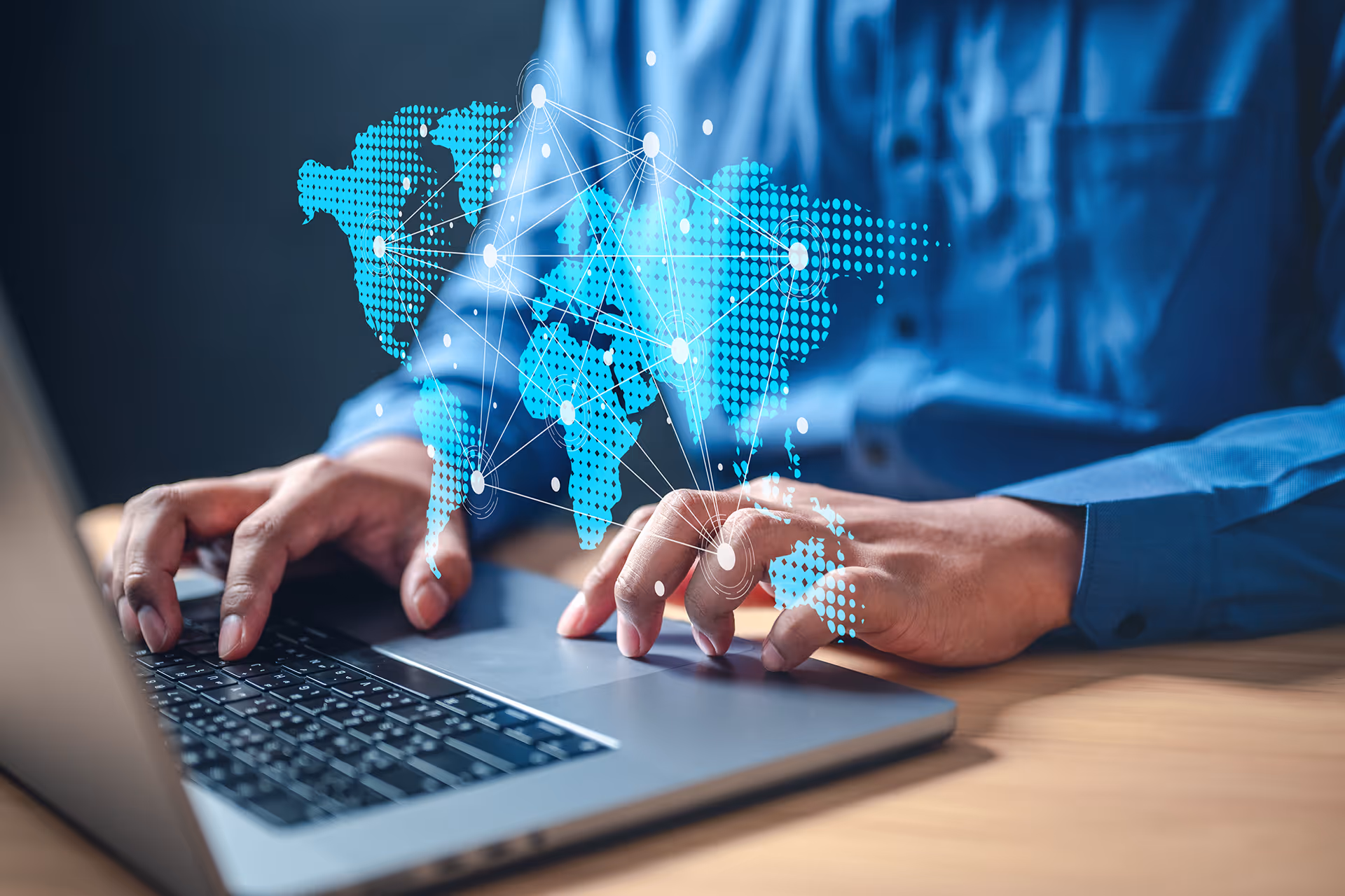 A holographic map of the world above a laptop