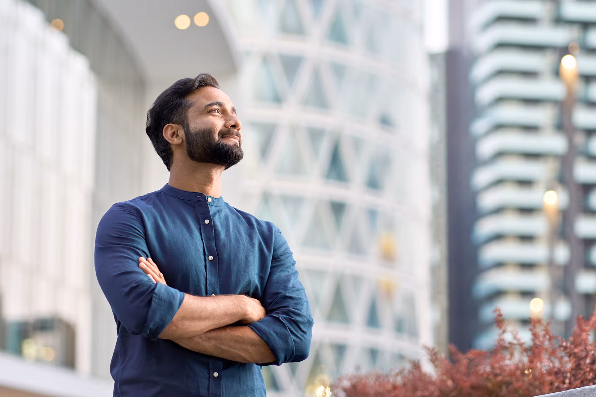 A man with his arms crossed looking into the distance