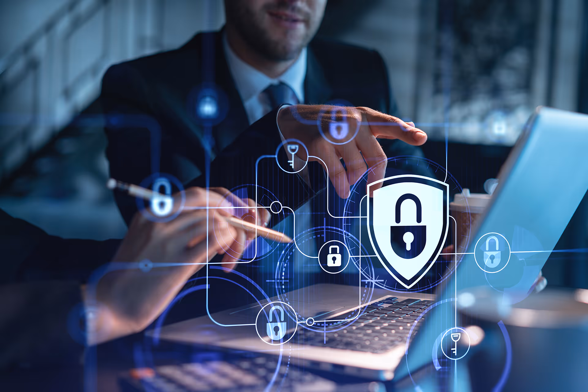 People working on a laptop with a secure padlock overlay — representing payments compliance