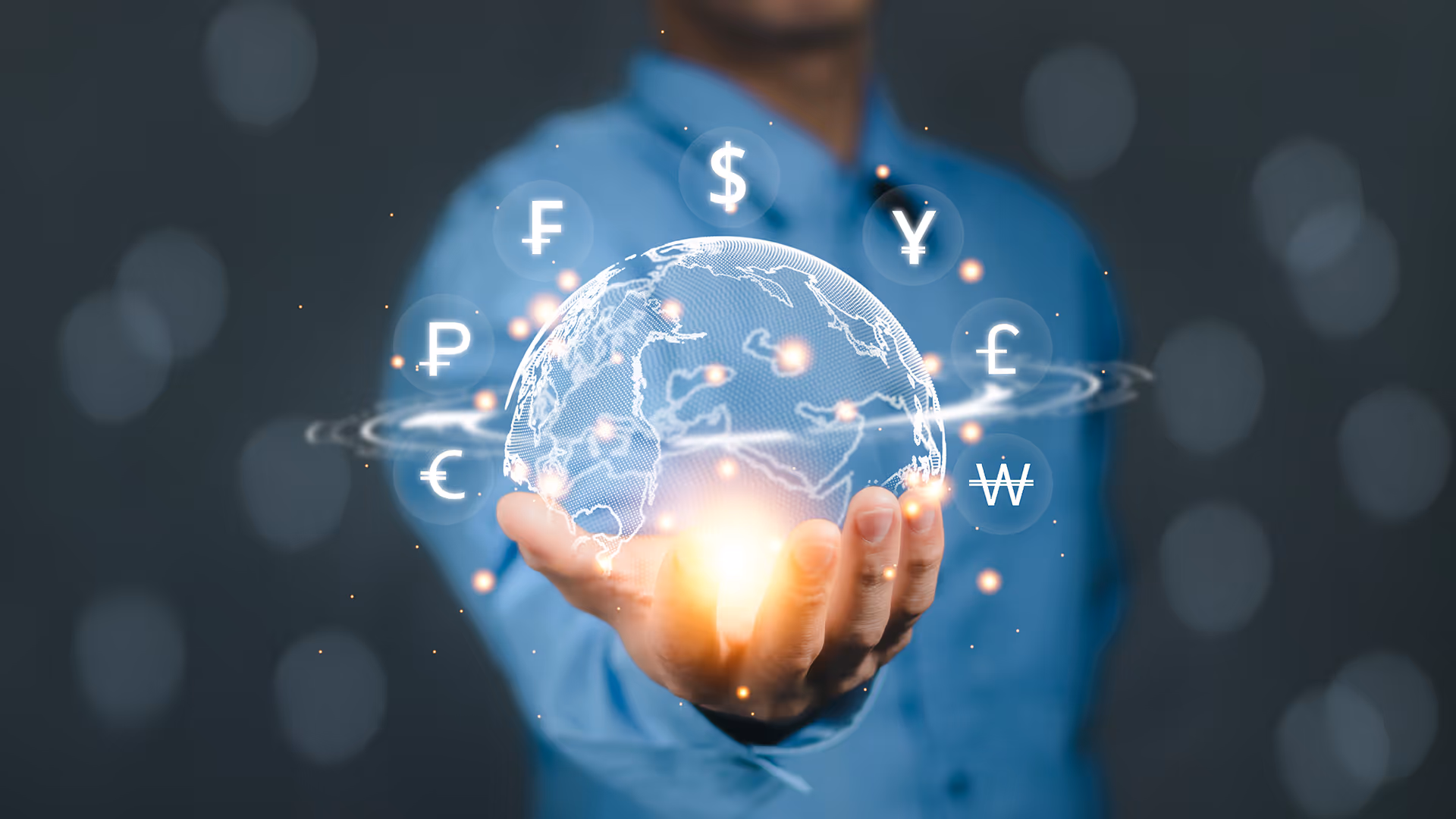 A man holding a hologram of a globe surrounded by currency symbols