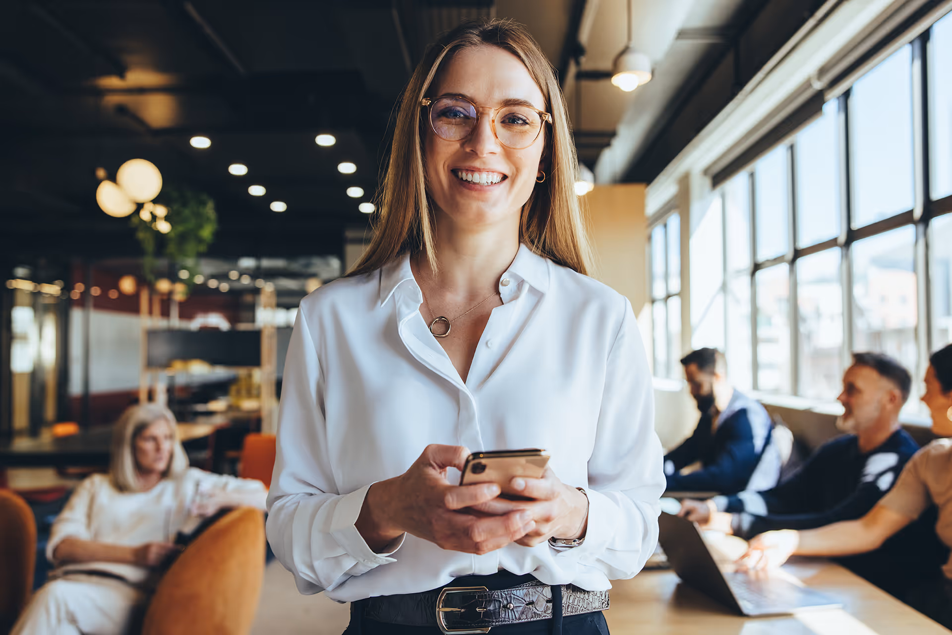 A smiling woman using a mobile phone