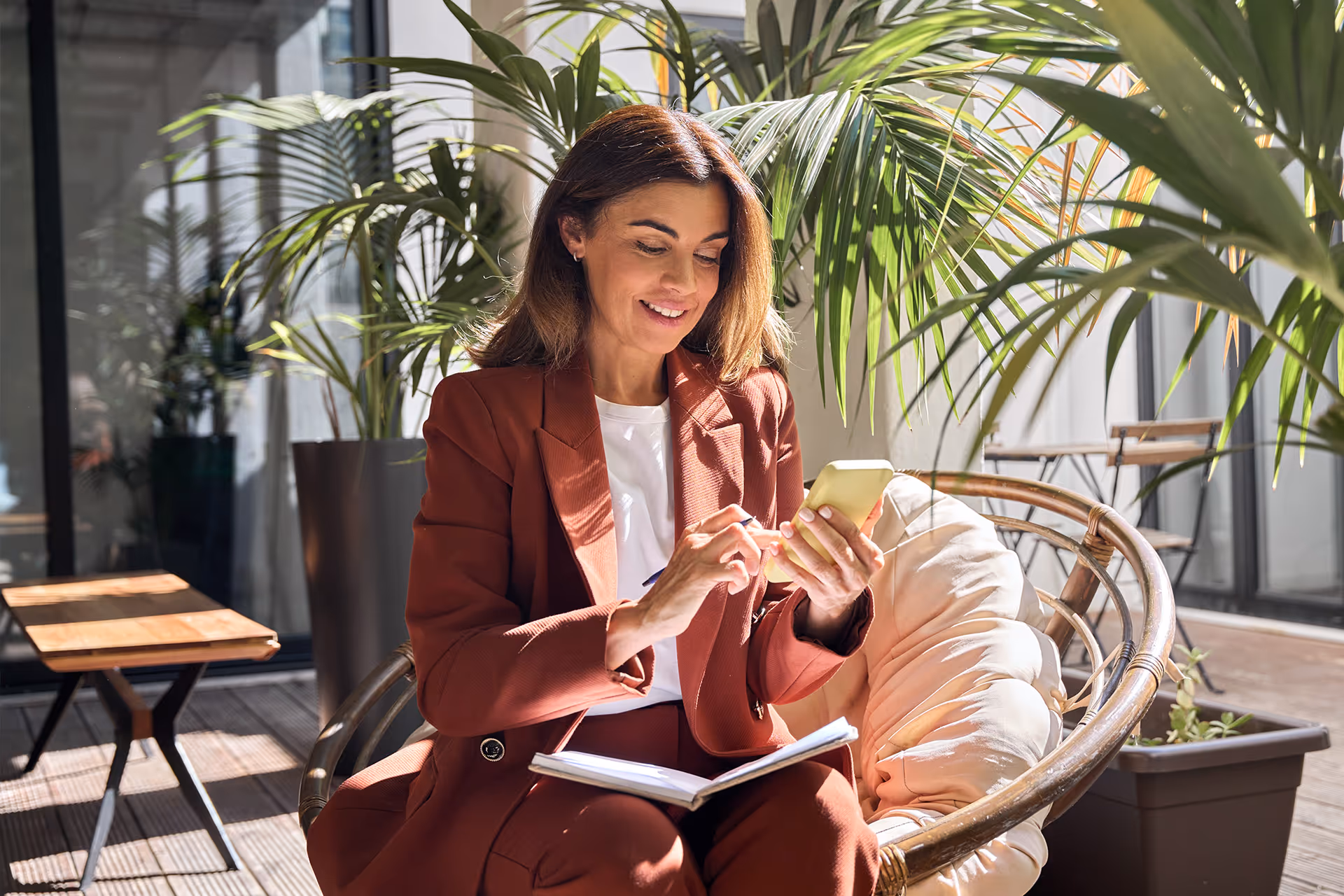 Business woman sat using phone