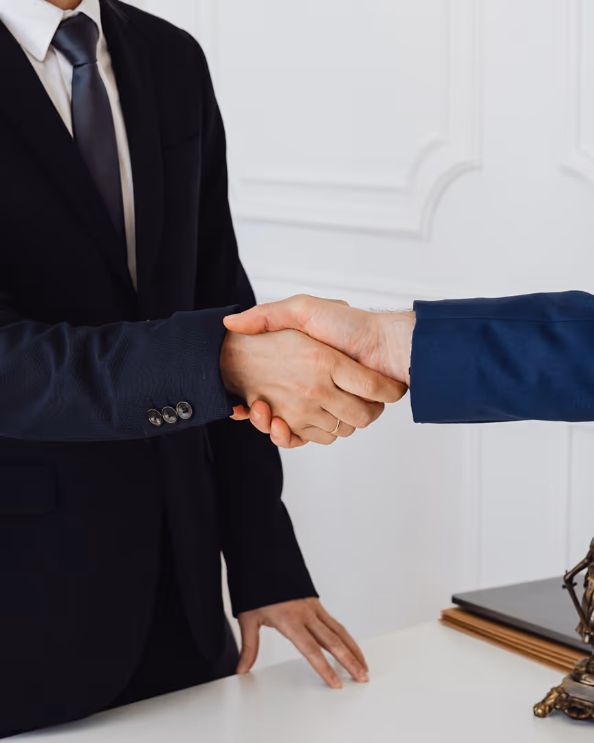 Businessmen shaking hands, representing diversified acquiring relationships
