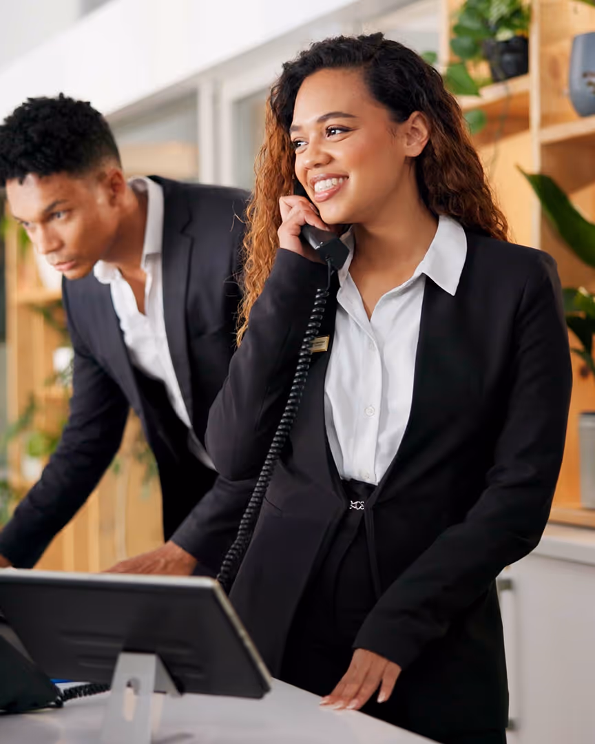 Hotel receptionist taking a phone call