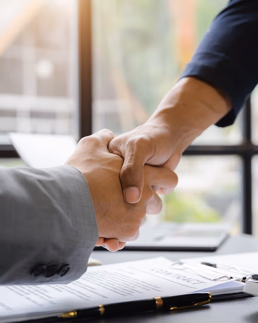 Shaking hands over a contract, representing payment partnerships