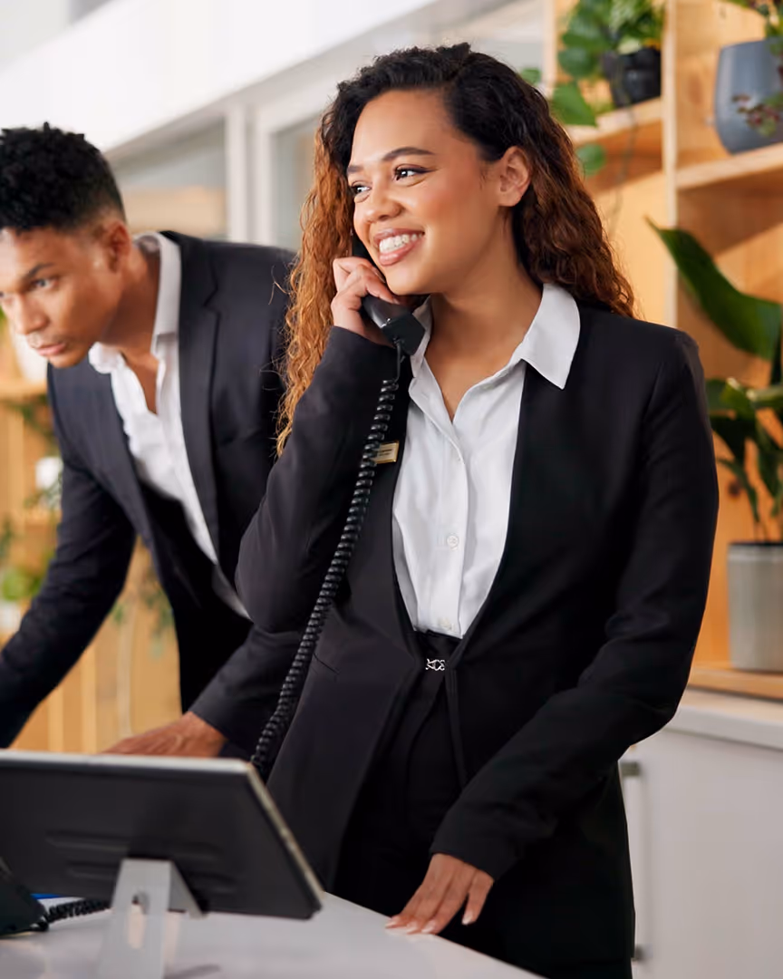 Hotel receptionist taking a phone call