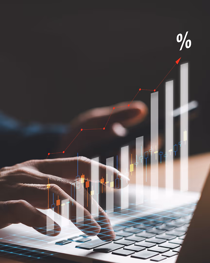 Climbing graph hovering over a laptop, representing the benefits of travel merchant accounts