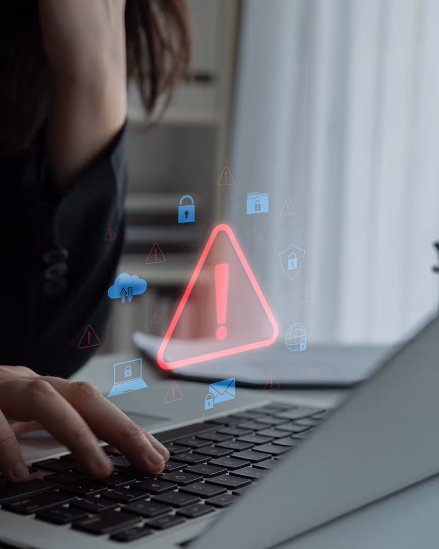 Holographic red exclamation mark floating over a laptop, representing choosing the wrong merchant account