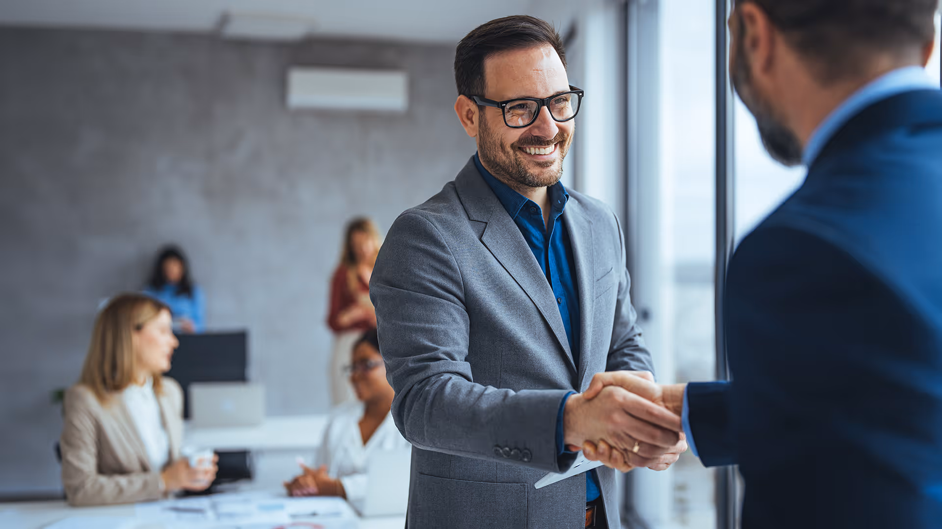 Businessmen shaking hands, representing becoming a Repayd partner