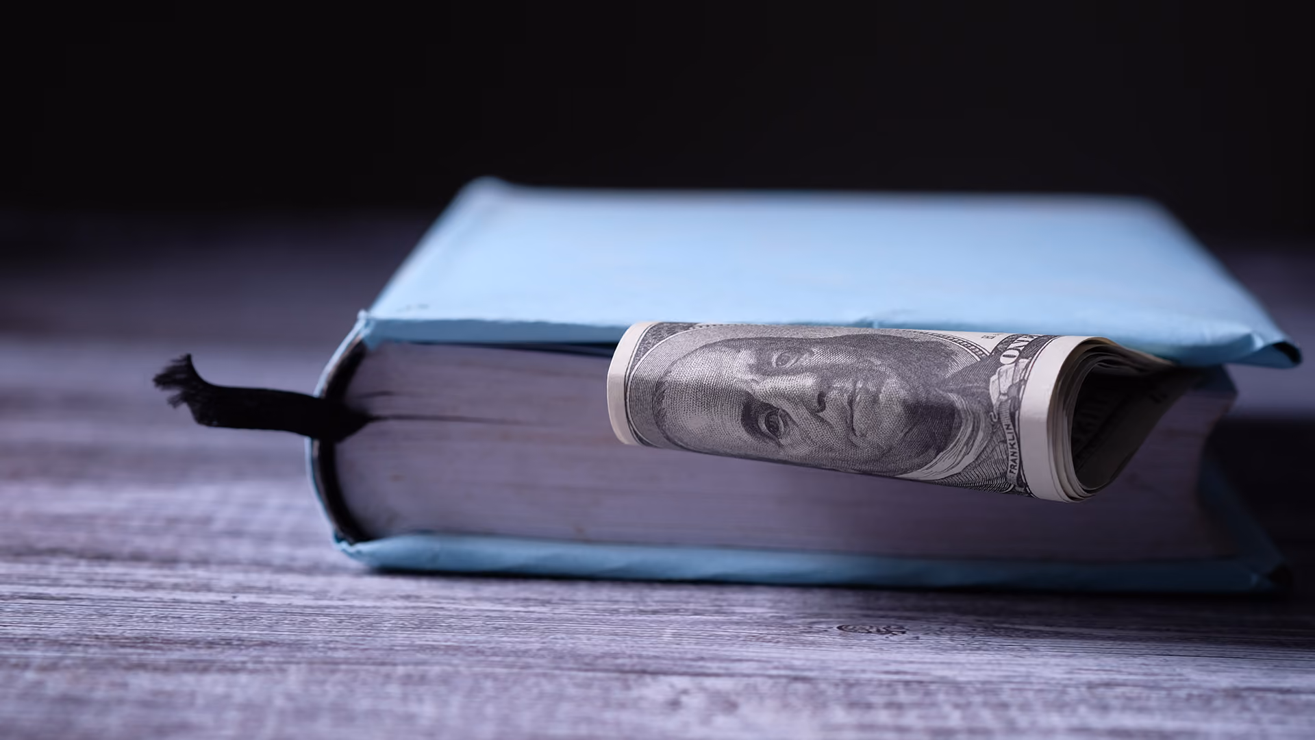 Book with money stored in it, representing the payments infrastructure handbook