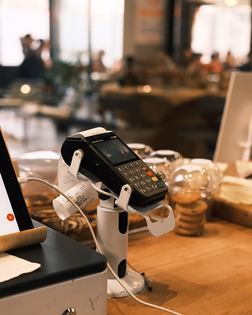 Chip and pin card machine in a shop, representing payments infrastructure