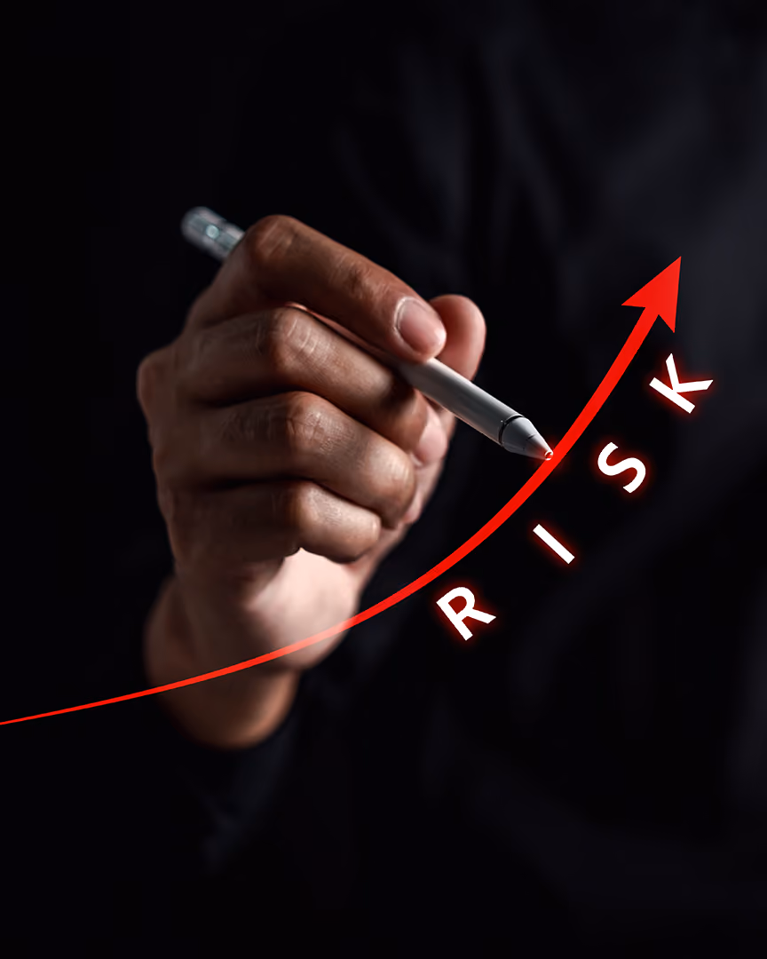 Man with pen drawing upwards arrow with word risk, representing payments risk