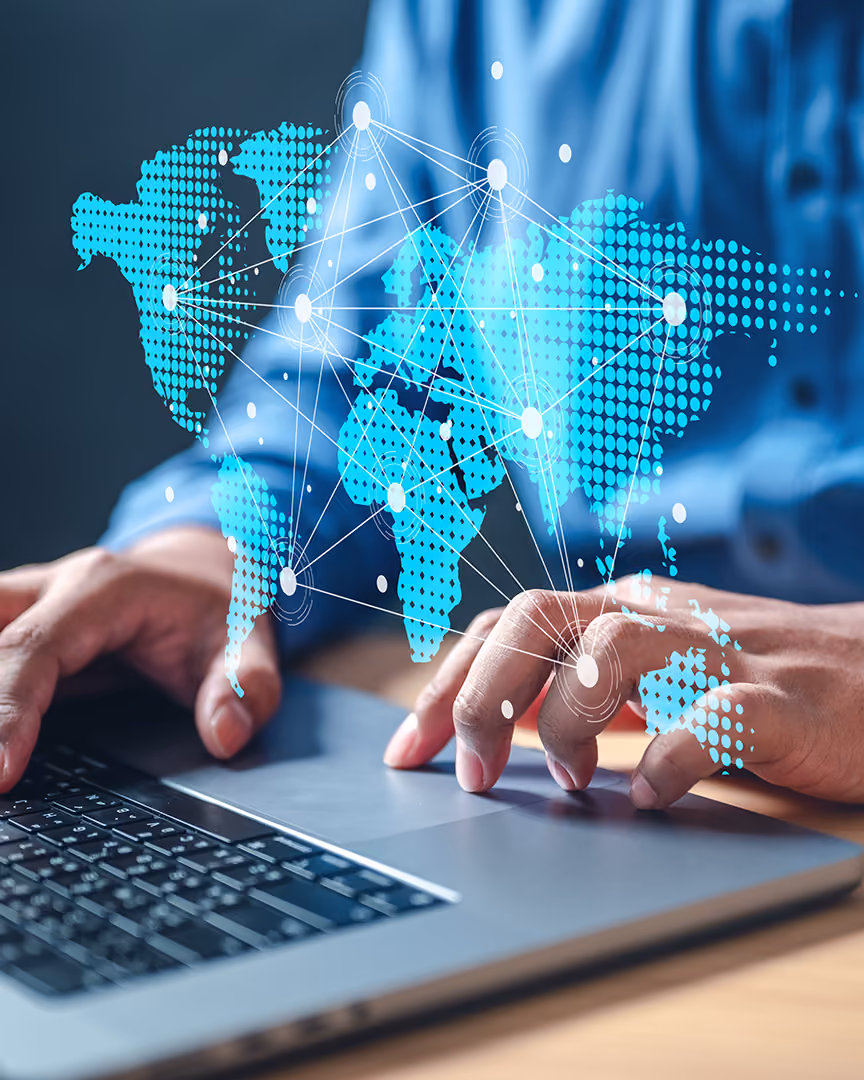Connected world map overlaid above a laptop, representing international travel payments