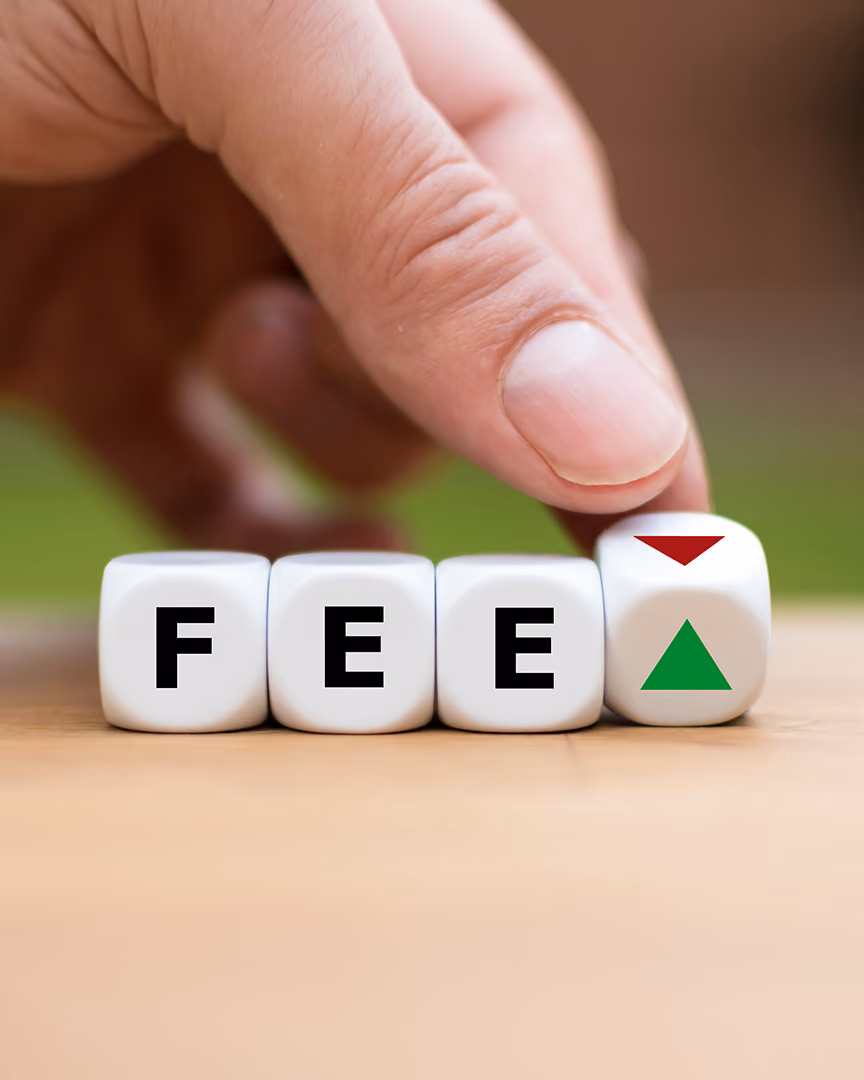 Dice showing reducing fees, representing lowering payment fees