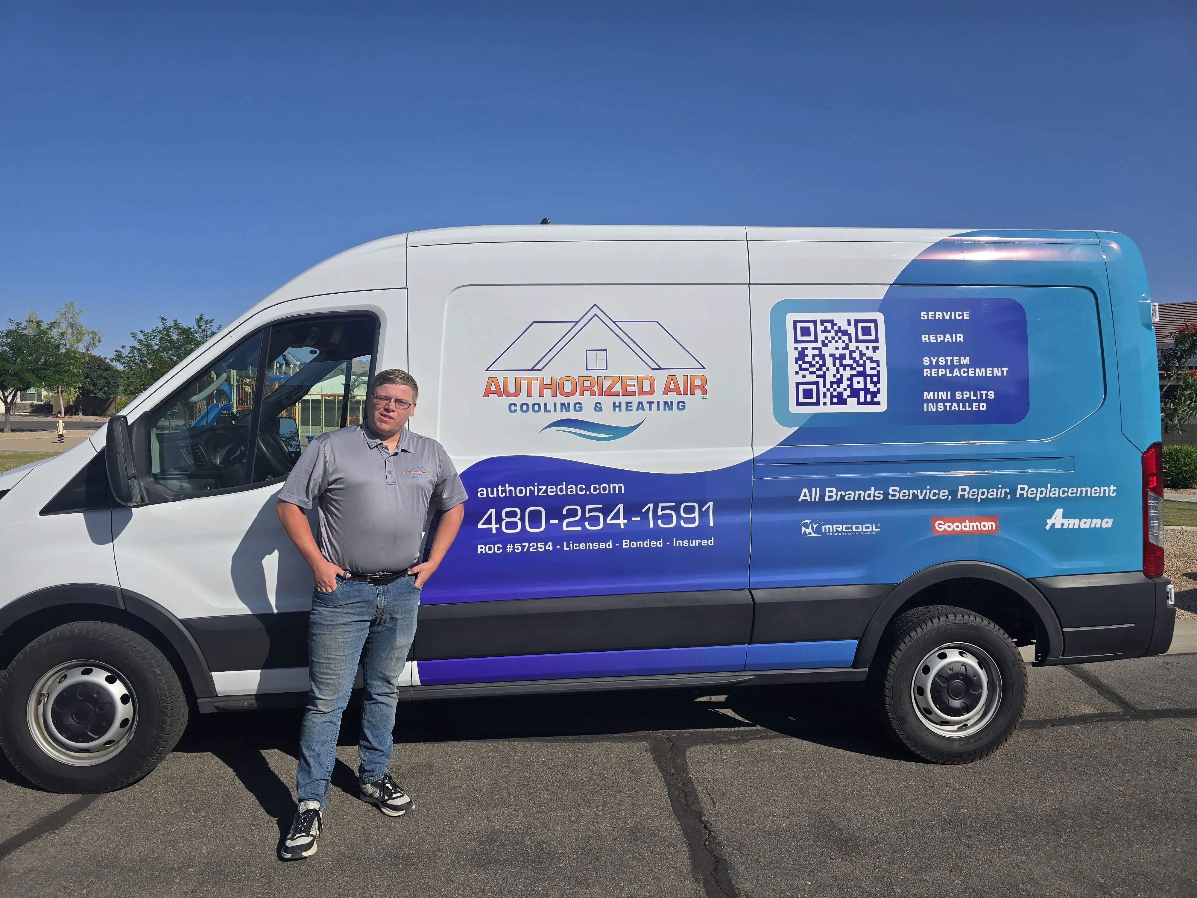 Authorized Air Cooling & Heating service van with technician standing beside it