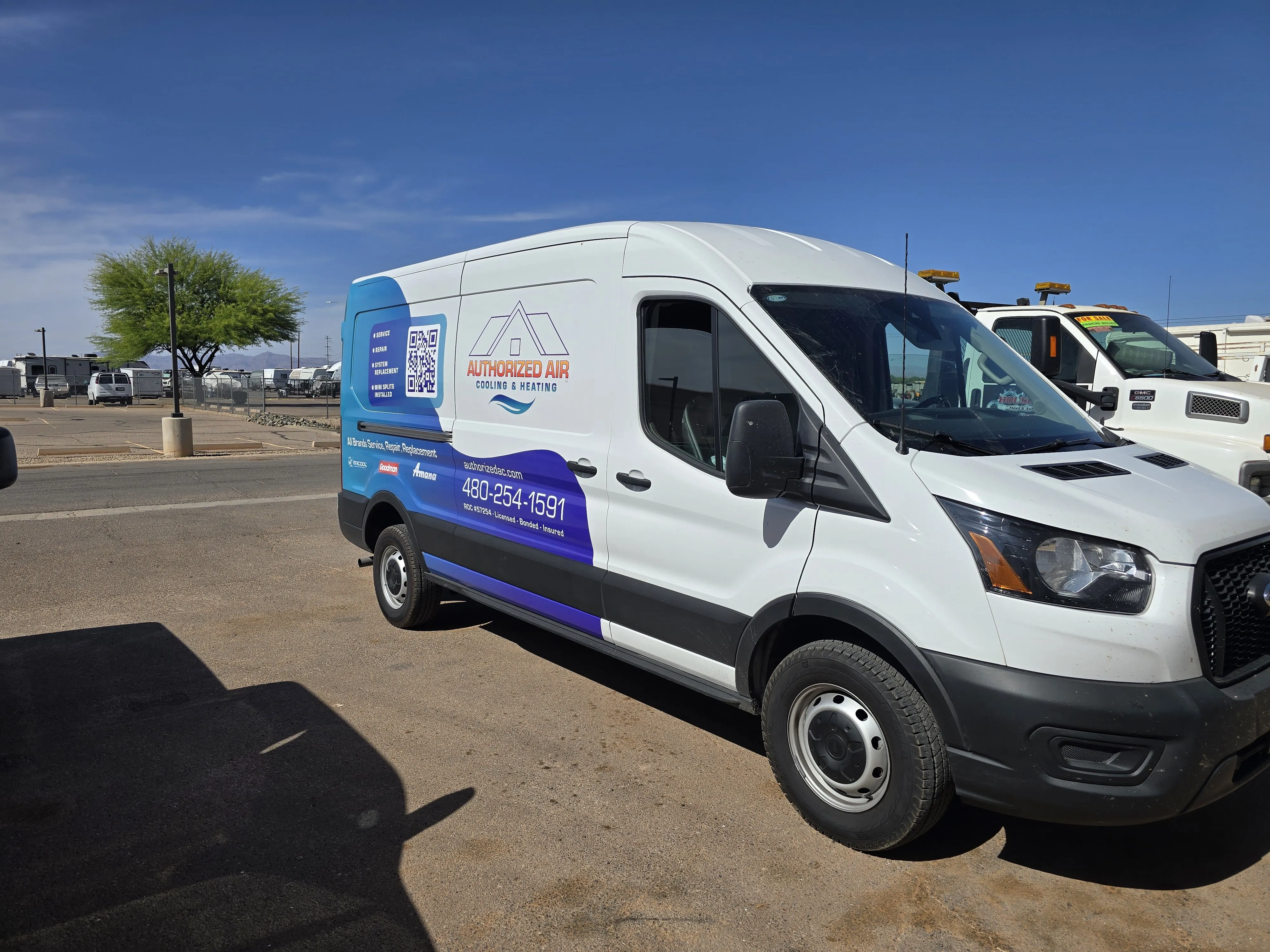 White and blue Authorized Air van parked in parking lot