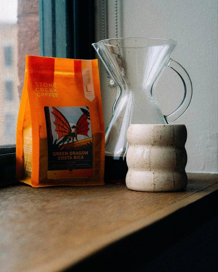 Coffee bag and pour-over carafe on a windowsill