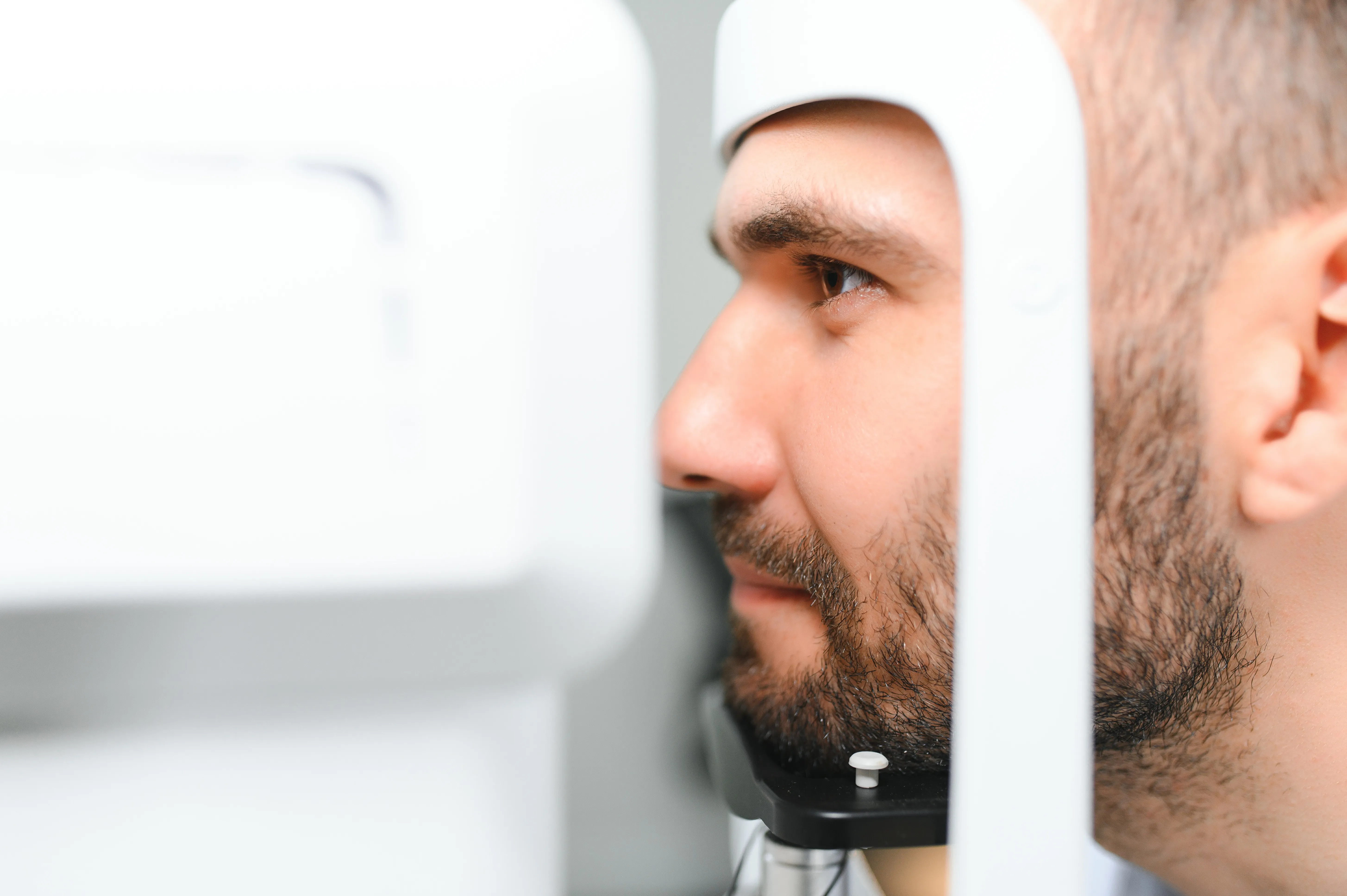 Person undergoing eye exam with medical equipment in close-up view