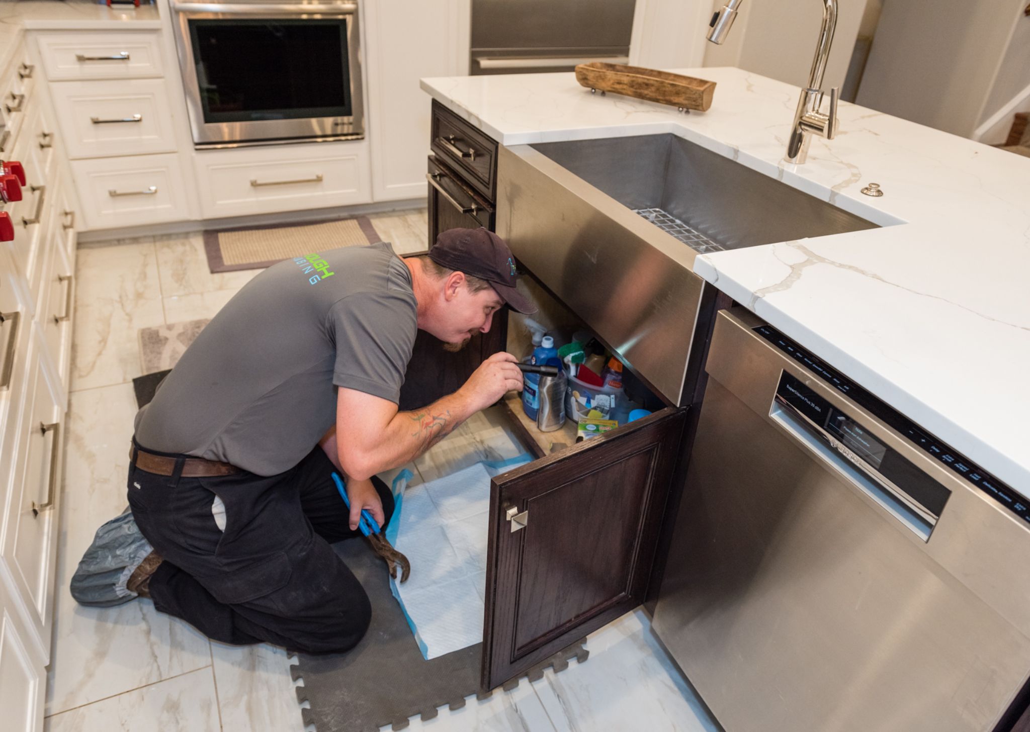 Close-up of a sink drain being cleared to remove buildup and restore smooth water flow.