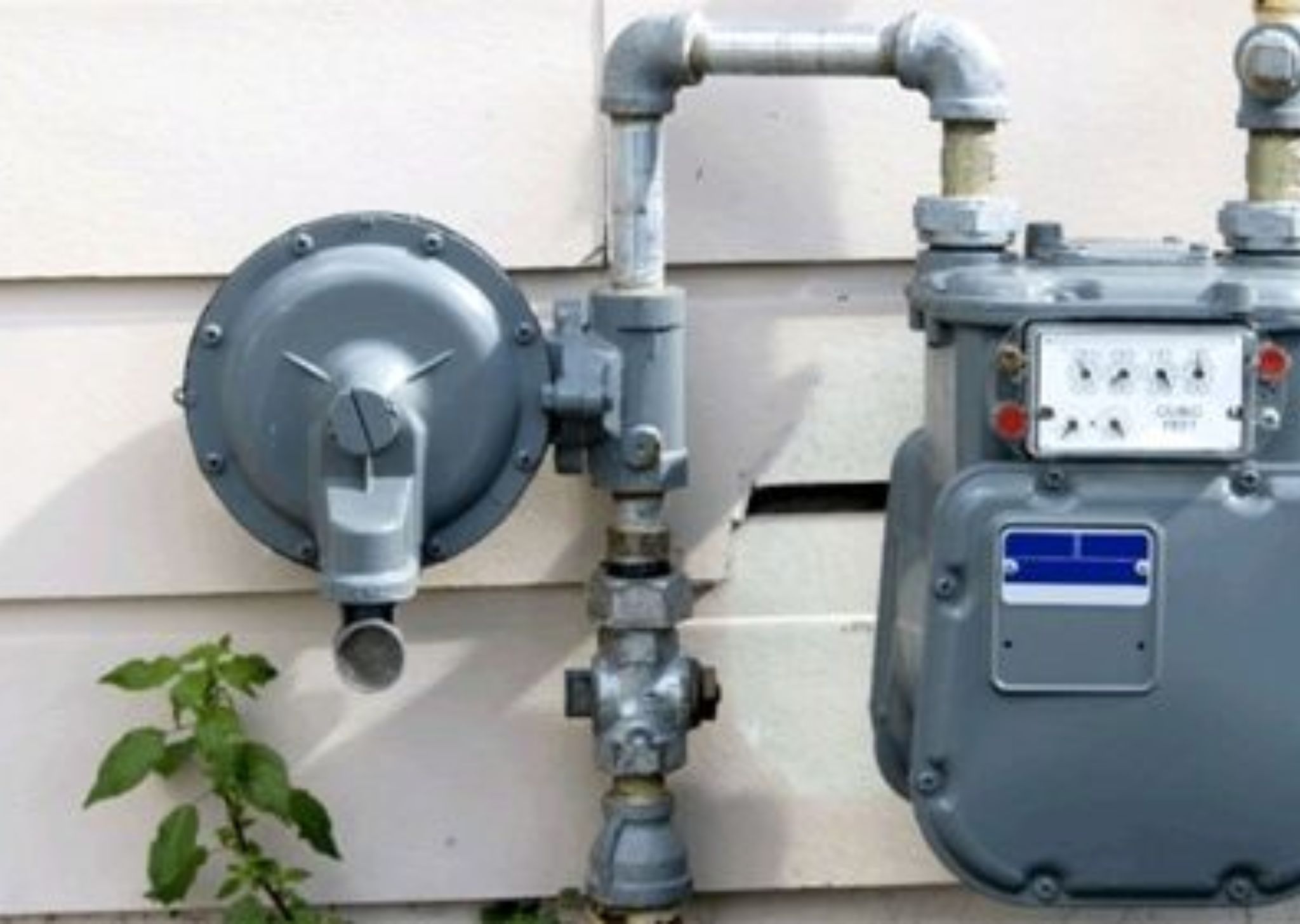 Close-up of a pump and valve system in a plumbing setup, controlling water flow and pressure.