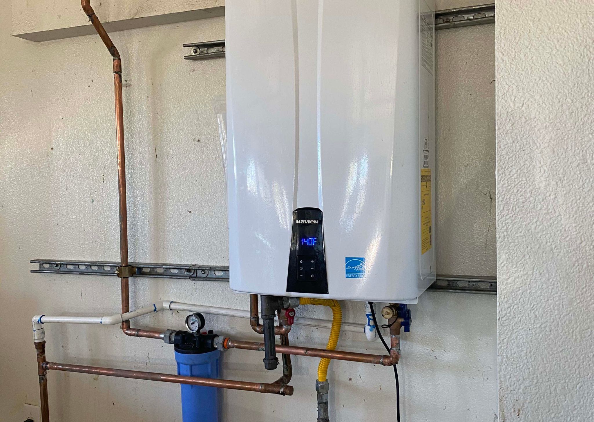 Technician servicing a tankless water heater to restore hot water performance.