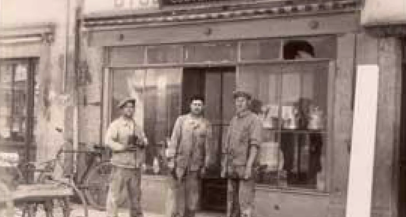 Vintage photo of soldiers outside a store.